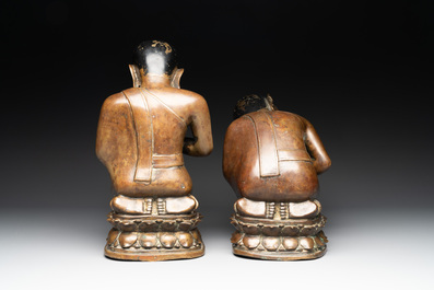 Two Burmese partly lacquered bronze praying monks, 18/19th C.