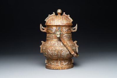 A Chinese archaistic bronze 'you 卣' vessel and cover, an inkstone and two calligraphy brushes, 20th C.