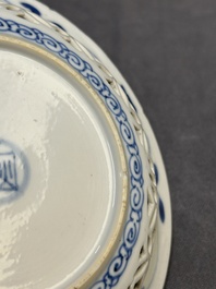 A Chinese blue and white reticulated double-walled cup and saucer, fu mark, Kangxi