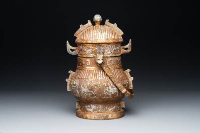 A Chinese archaistic bronze 'you 卣' vessel and cover, an inkstone and two calligraphy brushes, 20th C.