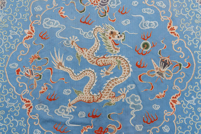 A Chinese blue-ground embroidered silk panel with a dragon among bajixiang, 19th C.