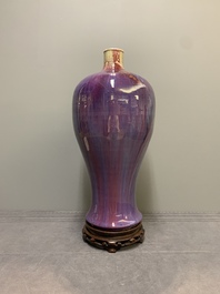 A Chinese flamb&eacute;-glazed 'meiping' vase on wooden stand, 18/19th C.