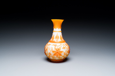 A pair of Chinese blue-overlay white Beijing glass vases with mandarin ducks and a orange-overlay white bottle vase, 19/20th C.