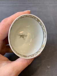A Chinese blue-enamelled gilt-decorated grisaille cup and saucer, Yongzheng