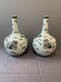 A pair of Chinese famille verte relief-decorated 'animals' vases, 19th C.