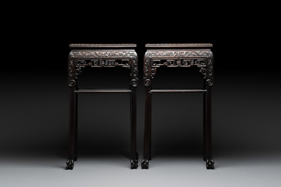 A pair of Chinese famille verte 'narrative' plaques mounted in hardwood tables, 19th C.