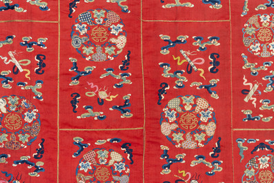 A Chinese red-ground embroidered silk 'bajixiang' panel, Tie Shan Si 鐵山寺 mark, 19th C.