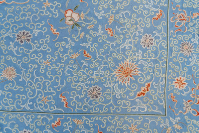 A Chinese blue-ground embroidered silk panel with a dragon among bajixiang, 19th C.