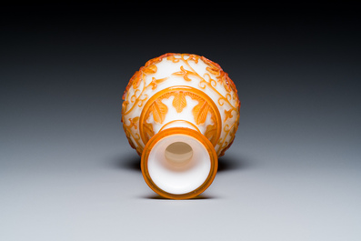 A pair of Chinese blue-overlay white Beijing glass vases with mandarin ducks and a orange-overlay white bottle vase, 19/20th C.