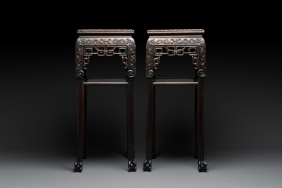 A pair of Chinese famille verte 'narrative' plaques mounted in hardwood tables, 19th C.