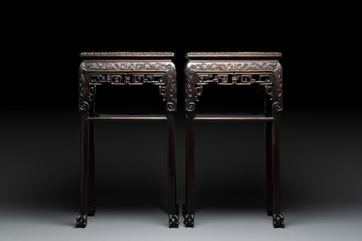 A pair of Chinese famille verte 'narrative' plaques mounted in hardwood tables, 19th C.