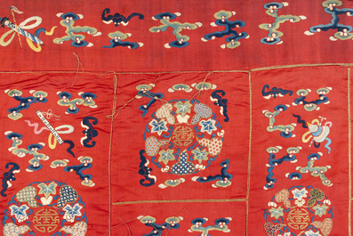 A Chinese red-ground embroidered silk 'bajixiang' panel, Tie Shan Si 鐵山寺 mark, 19th C.