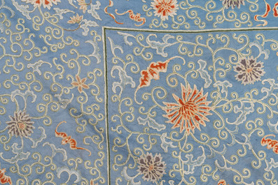 A Chinese blue-ground embroidered silk panel with a dragon among bajixiang, 19th C.