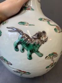 A pair of Chinese famille verte relief-decorated 'animals' vases, 19th C.
