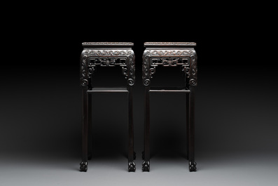 A pair of Chinese famille verte 'narrative' plaques mounted in hardwood tables, 19th C.