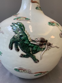 A pair of Chinese famille verte relief-decorated 'animals' vases, 19th C.