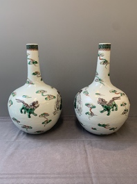A pair of Chinese famille verte relief-decorated 'animals' vases, 19th C.