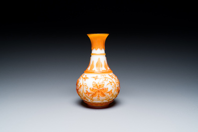 A pair of Chinese blue-overlay white Beijing glass vases with mandarin ducks and a orange-overlay white bottle vase, 19/20th C.