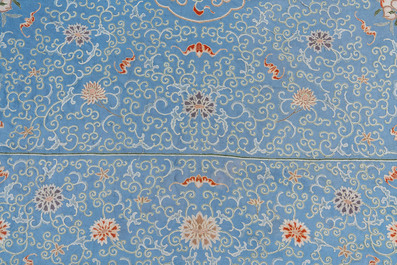 A Chinese blue-ground embroidered silk panel with a dragon among bajixiang, 19th C.