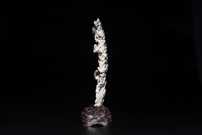 A Chinese white coral group of goddesses on wooden stand, 19/20th C.