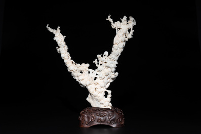 A Chinese white coral group of goddesses on wooden stand, 19/20th C.