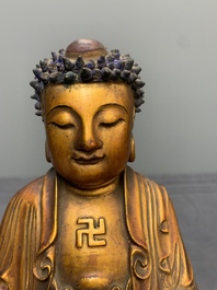 A fine Chinese gilt-lacquered wooden figure of the standing Buddha, Ming