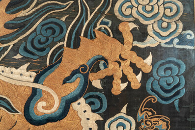 A Chinese embroidered silk tapestry with a five-clawed dragon among clouds and bajixiang, 18/19th C.