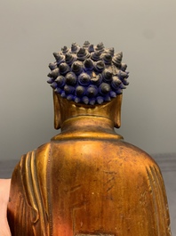 A fine Chinese gilt-lacquered wooden figure of the standing Buddha, Ming