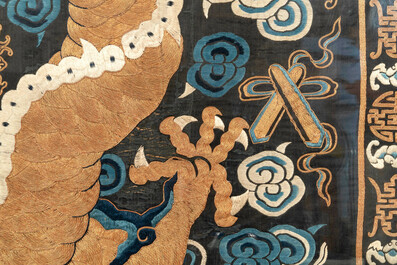 A Chinese embroidered silk tapestry with a five-clawed dragon among clouds and bajixiang, 18/19th C.