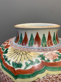 A Chinese wucai 'Buddhist lion and peony scroll' vase, Transitional period