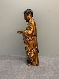A fine Chinese gilt-lacquered wooden figure of the standing Buddha, Ming