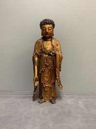 A fine Chinese gilt-lacquered wooden figure of the standing Buddha, Ming