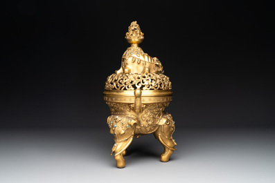 A large Chinese precious stone-inlaid gilt bronze 'elephant' tripod censer and cover on wooden stand, 19th C.