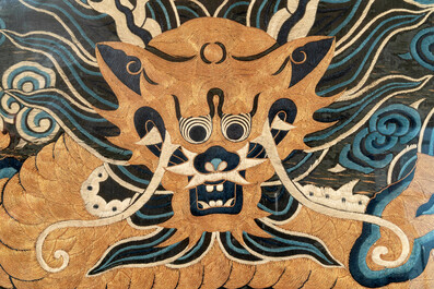 A Chinese embroidered silk tapestry with a five-clawed dragon among clouds and bajixiang, 18/19th C.