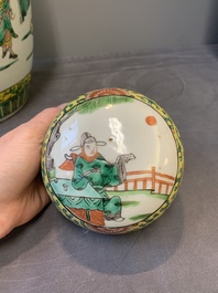 A pair of Chinese famille verte yellow-ground vases and covers with narrative design, 19th C.