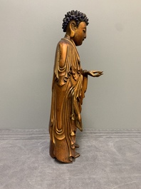 A fine Chinese gilt-lacquered wooden figure of the standing Buddha, Ming