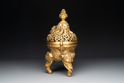 A large Chinese precious stone-inlaid gilt bronze 'elephant' tripod censer and cover on wooden stand, 19th C.