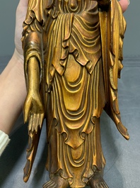 A fine Chinese gilt-lacquered wooden figure of the standing Buddha, Ming