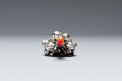 Two silver bottle stoppers, a tobacco box and a baby rattle with red coral teether, Germany, 19/20th C.