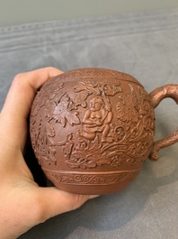 A Chinese Yixing stoneware teapot with boys among flower scrolls, Kangxi