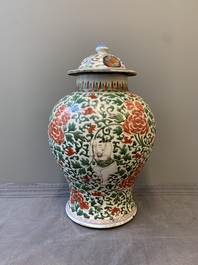 A Chinese wucai 'boy and peony scroll' vase and cover, 17th C.