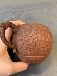 A Chinese Yixing stoneware teapot with boys among flower scrolls, Kangxi