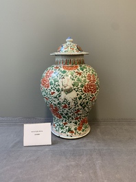 A Chinese wucai 'boy and peony scroll' vase and cover, 17th C.