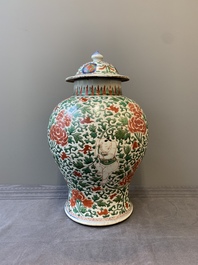 A Chinese wucai 'boy and peony scroll' vase and cover, 17th C.