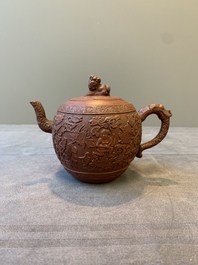 A Chinese Yixing stoneware teapot with boys among flower scrolls, Kangxi