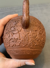 A Chinese Yixing stoneware teapot with boys among flower scrolls, Kangxi