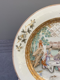 A fine pair of Chinese Canton famille rose 'ladies in the garden' plates, Yongzheng/Qianlong