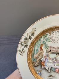 A fine pair of Chinese Canton famille rose 'ladies in the garden' plates, Yongzheng/Qianlong