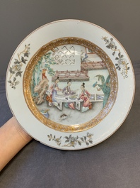 A fine pair of Chinese Canton famille rose 'ladies in the garden' plates, Yongzheng/Qianlong