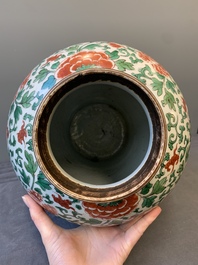 A Chinese wucai 'boy and peony scroll' vase and cover, 17th C.